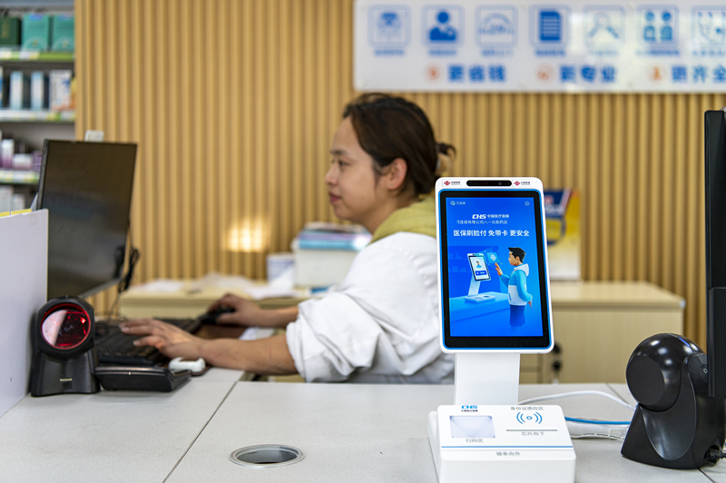 2024年4月10日，浙江金華市區(qū)一家民眾大藥房柜臺(tái)上設(shè)置著醫(yī)?！八⒛樦Ц丁睓C(jī)器，群眾看病更加便利。